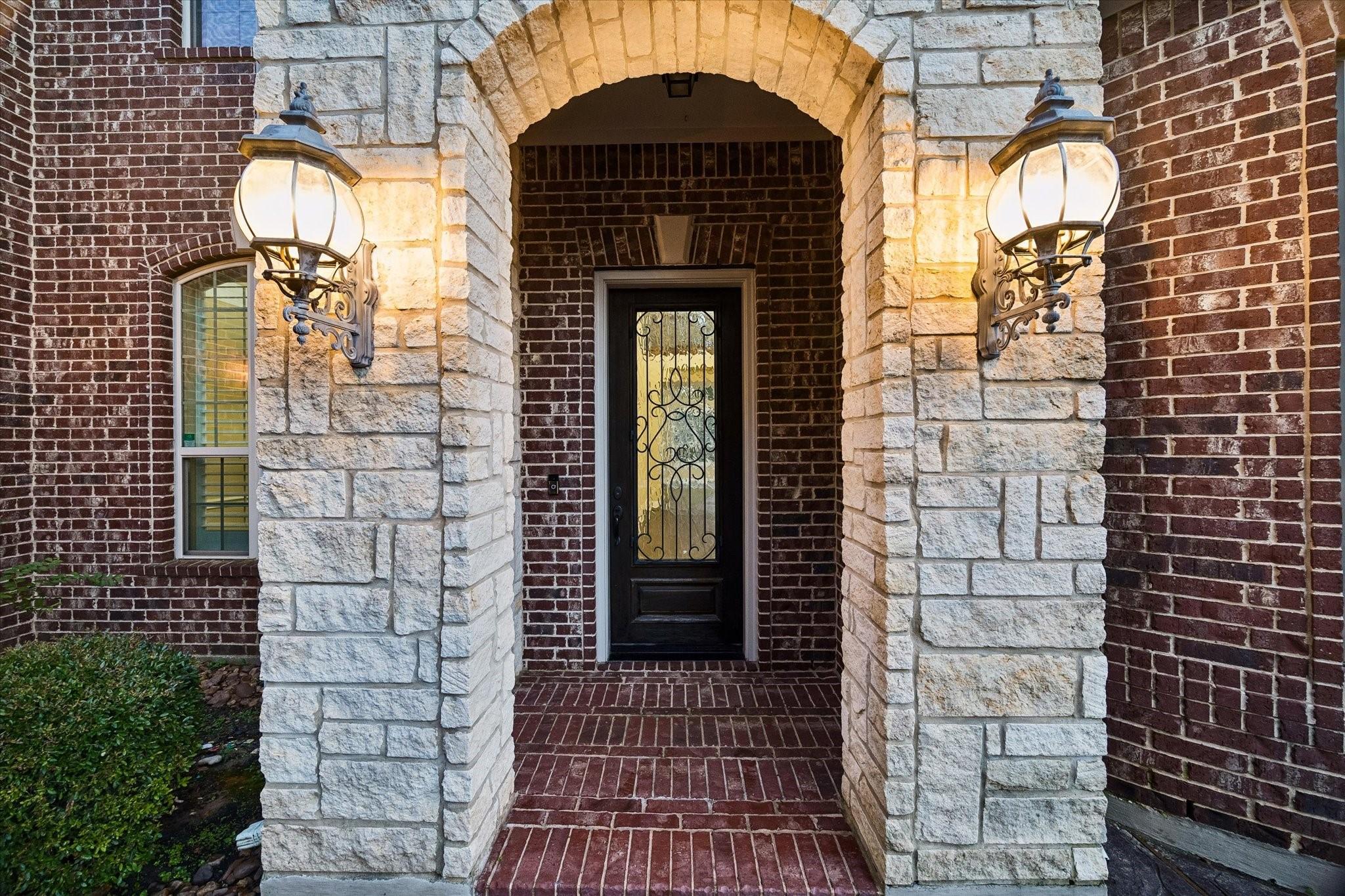 Image 2: The elegant entry welcomes guests with timeless ar