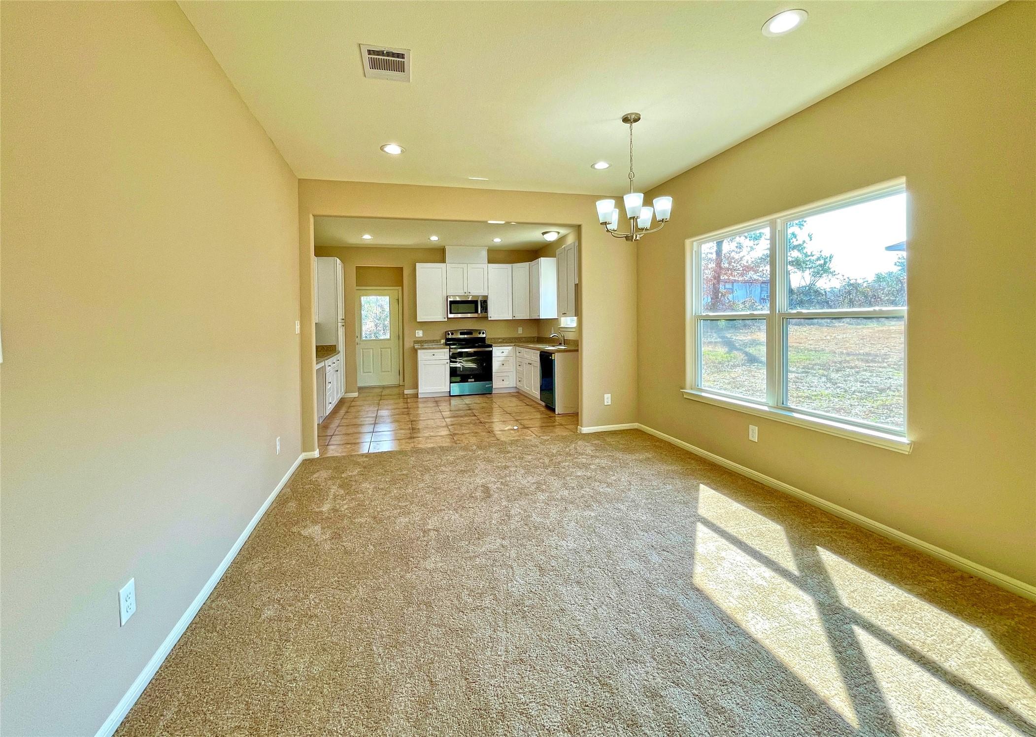 Image 4: The view into the kitchen from the dining area is