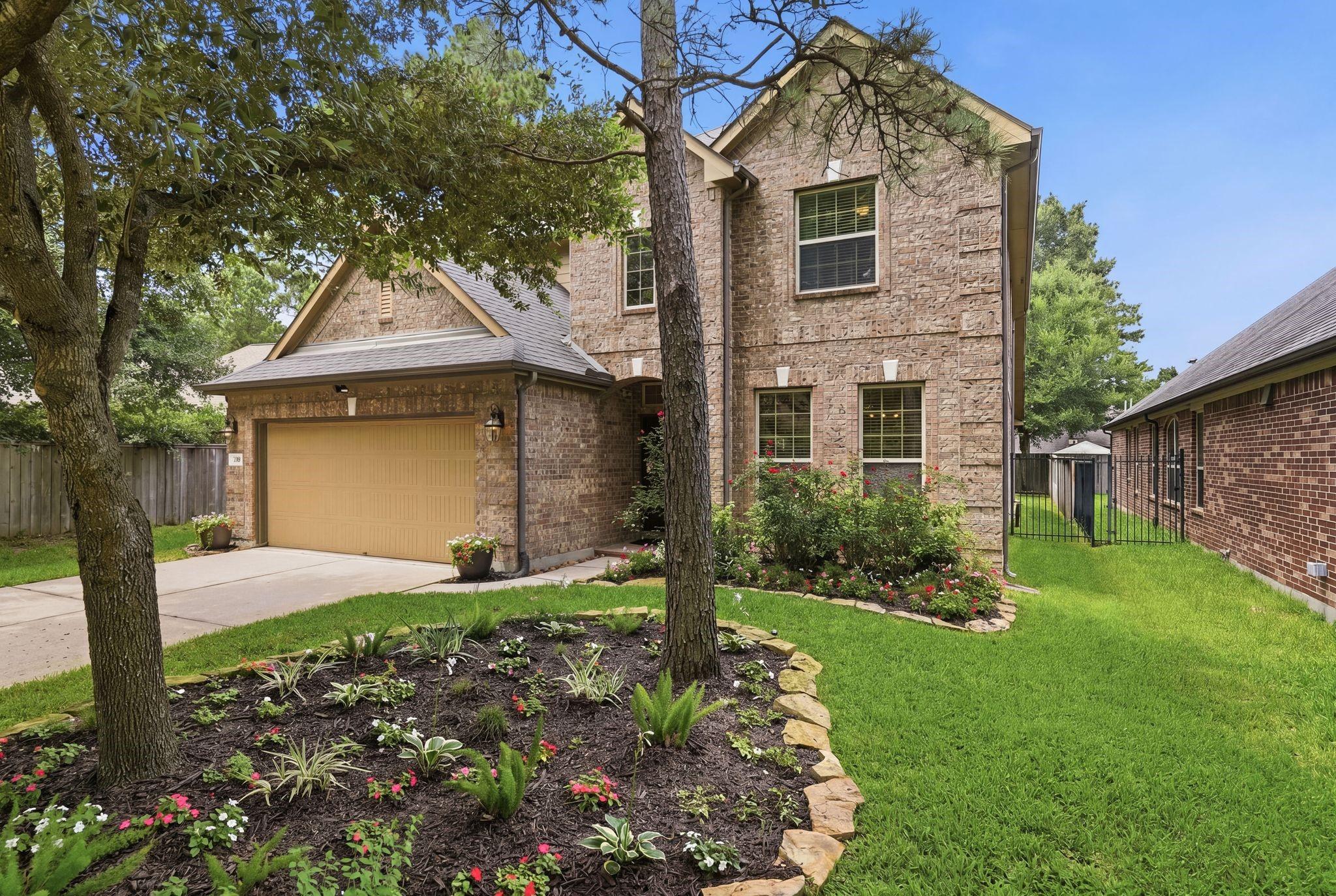 Image 2: Beautiful home with mature landscaping.
