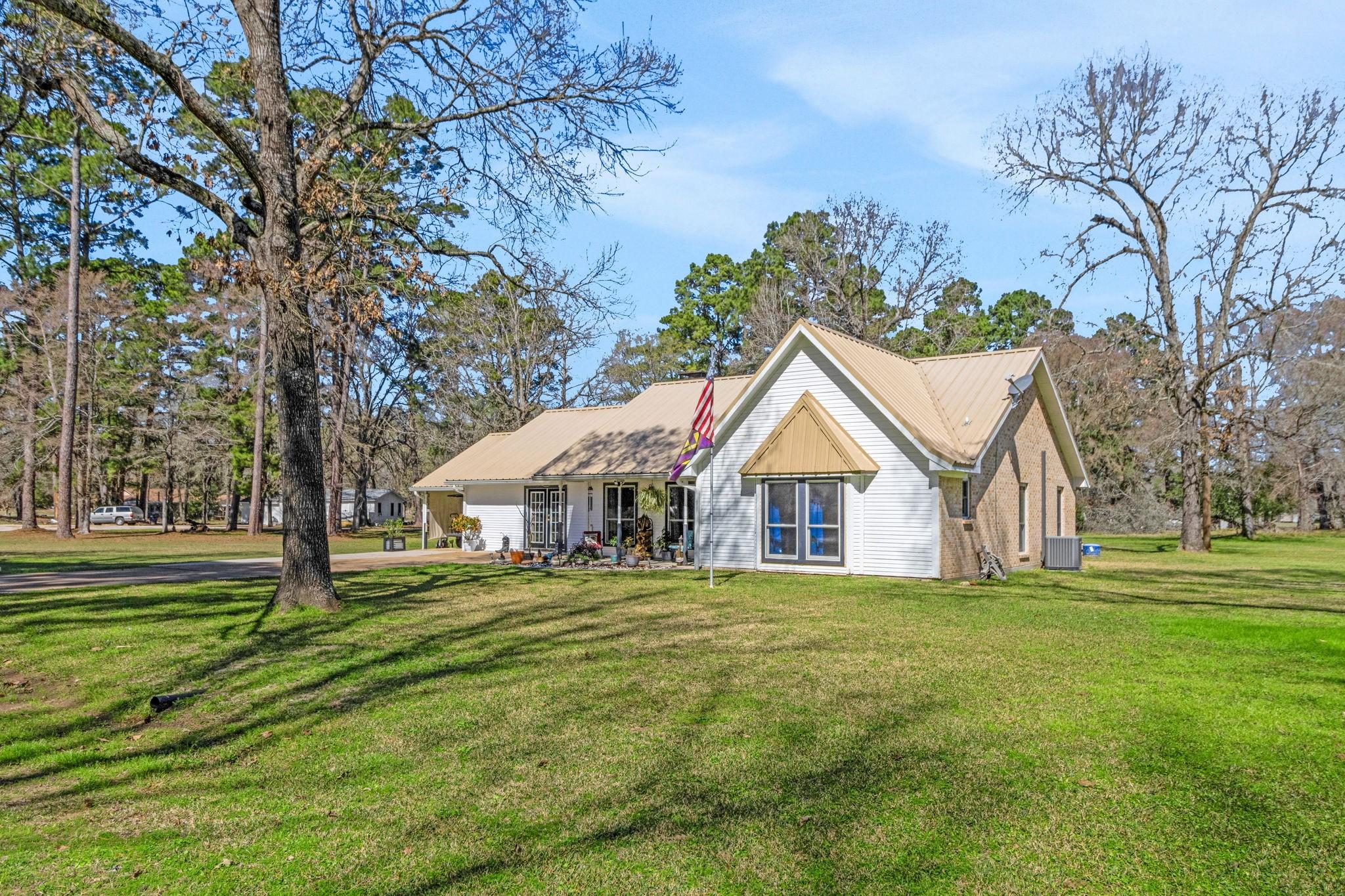 Image 4: Nestled on three expansive lots, this charming hom