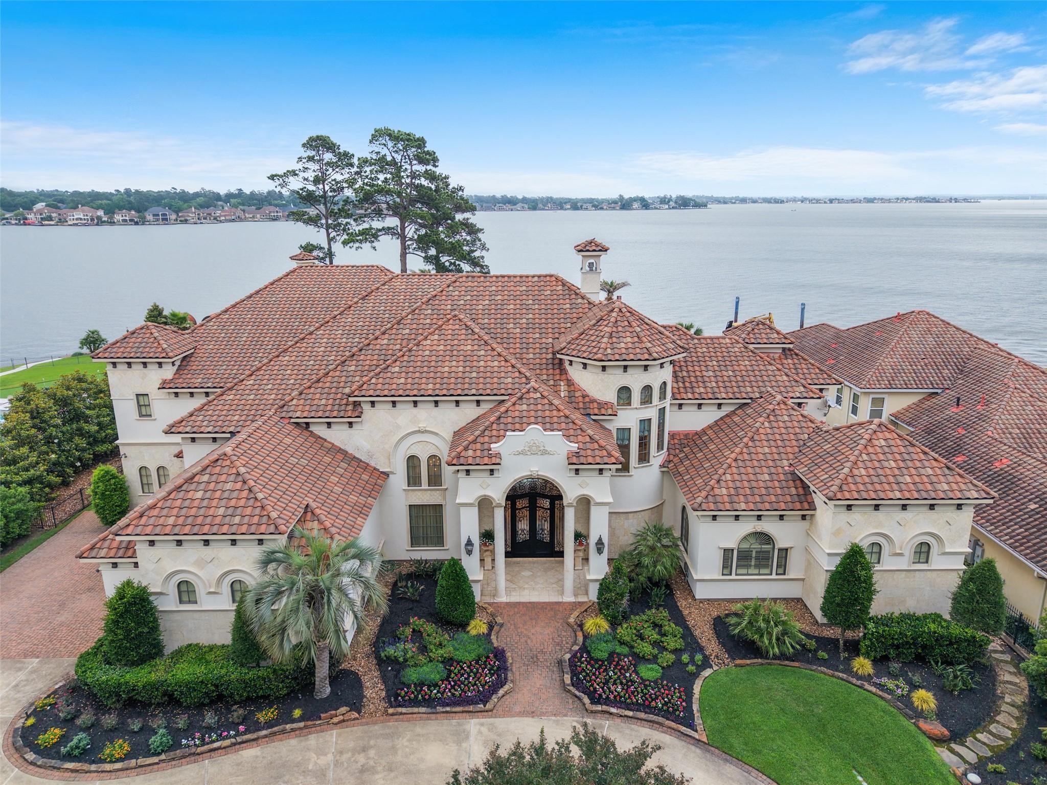 Image 2: This stunning waterfront estate features a Mediter