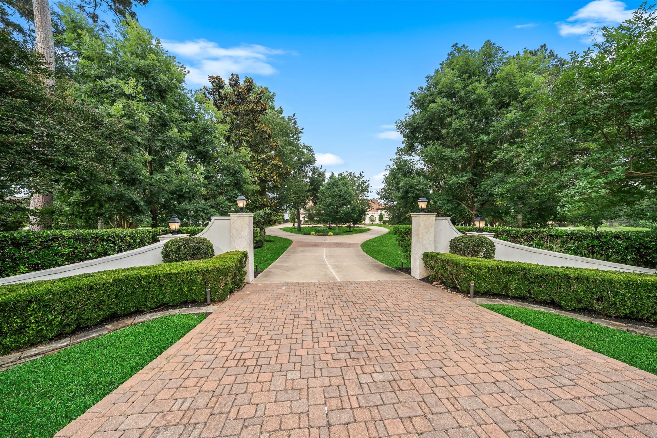 Image 3: This photo showcases a beautifully landscaped driv