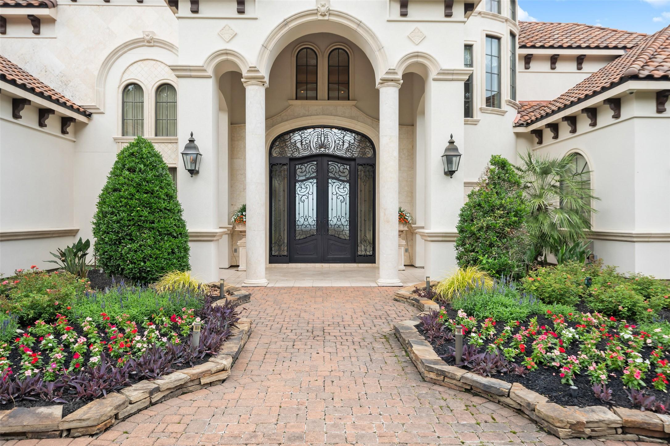 Image 4: This elegant home entrance features a grand arched