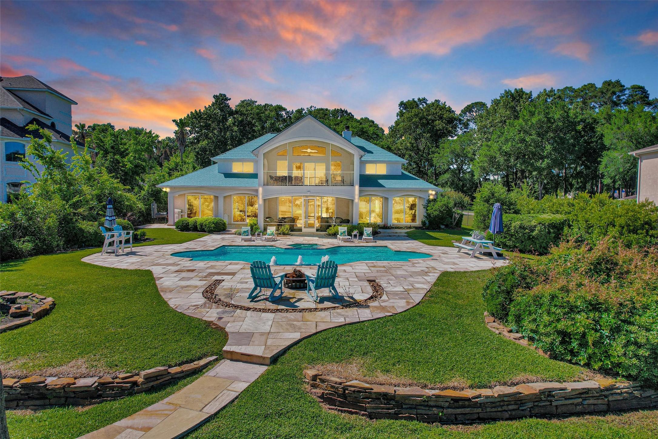 Image 1: This stunning property features a spacious backyar
