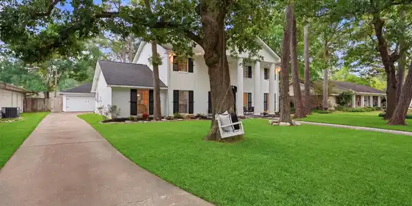 Image 2: Beautifully positioned beneath mature trees, this