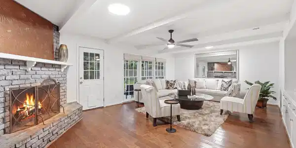 Image 4: Spacious living area featuring hardwood floors, ab