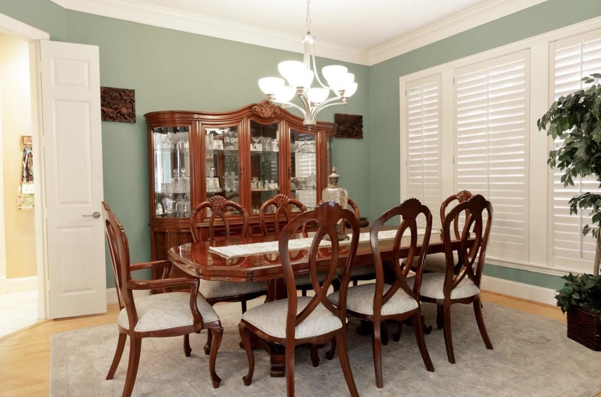 Image 4: Elegant formal dining room with abundant natural l