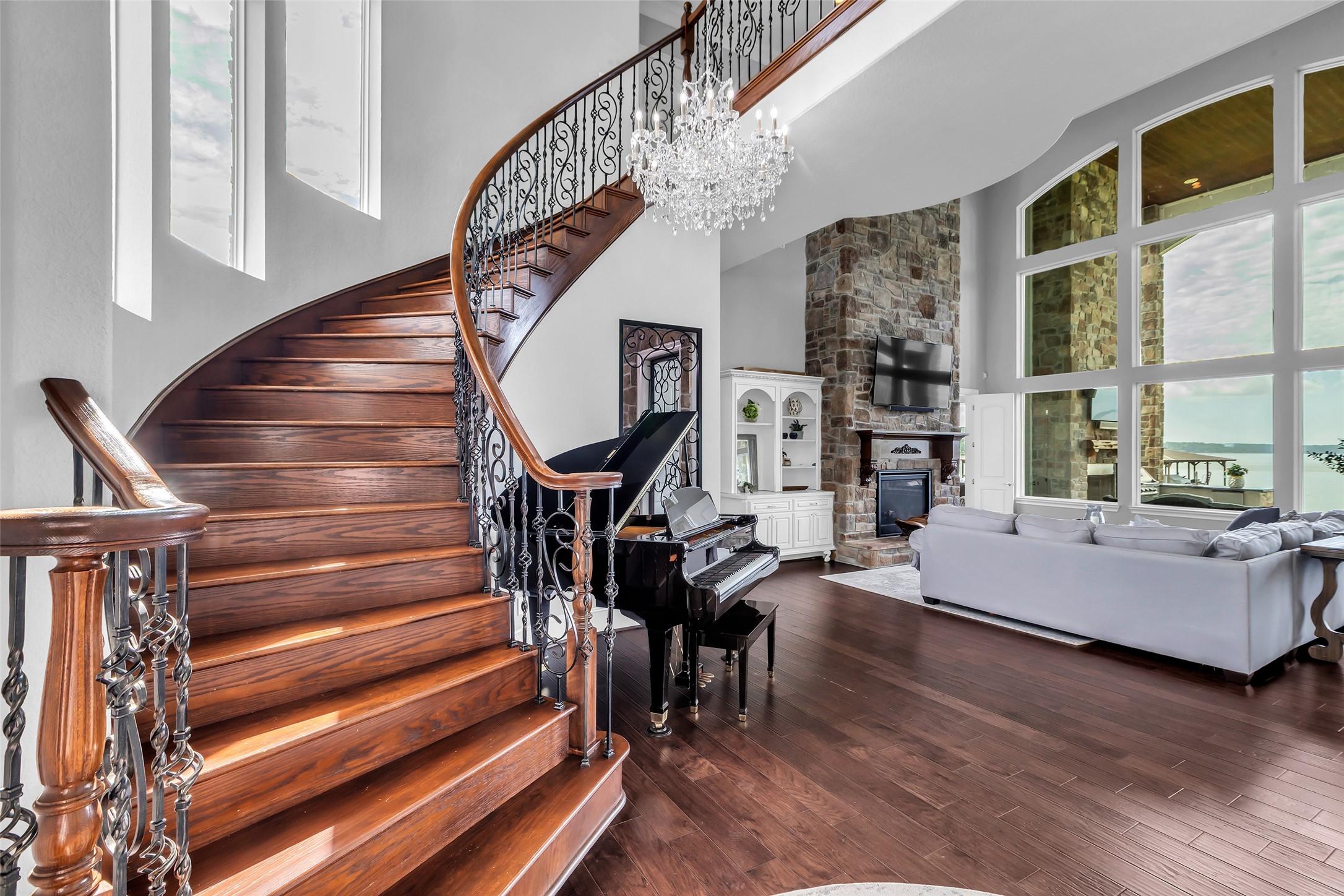 Image 3: This elegant living area features a grand wooden s