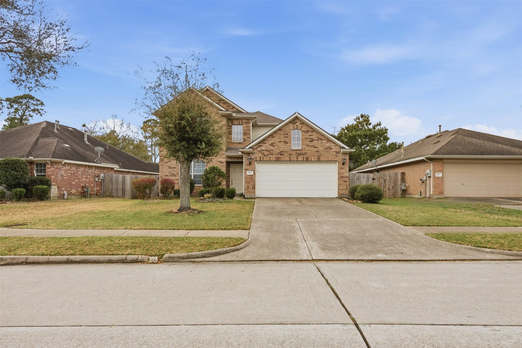Image 2: Wide street view showcasing the home&rsquo;s curb appeal