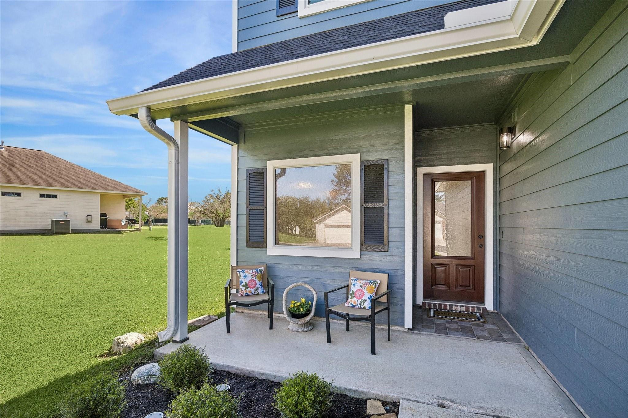 Image 3: Charming shaded front porch offers a welcoming spo