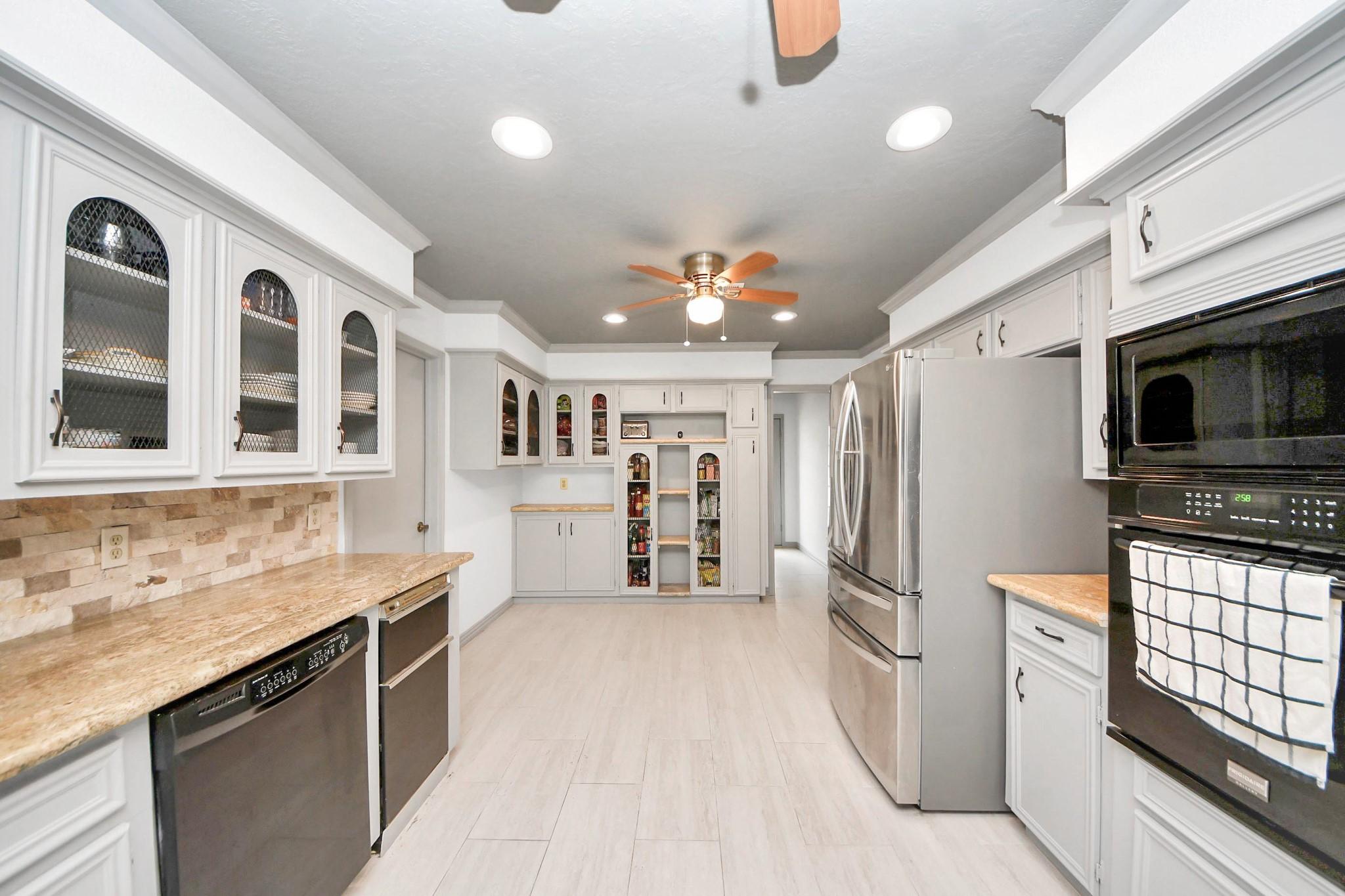 Image 3: Bright, spacious kitchen with modern stainless ste