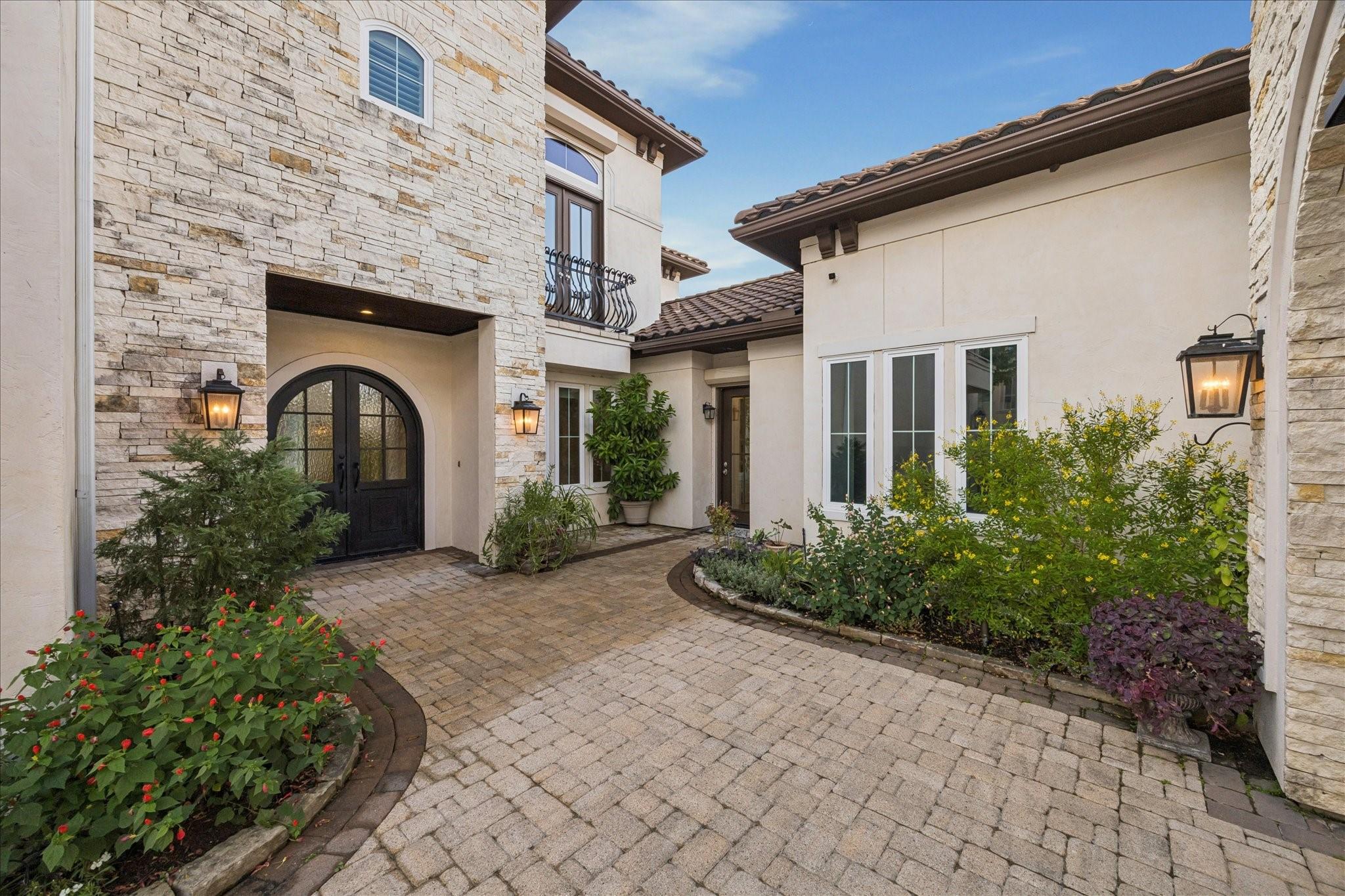 Image 3: The charming courtyard entrance with stone and stu
