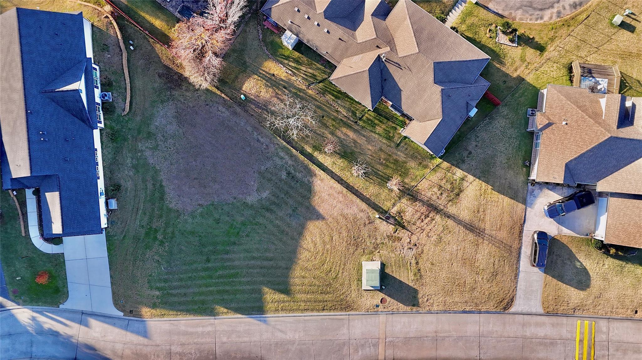 Image 3: Aerial perspective of the cleared lot with paved r