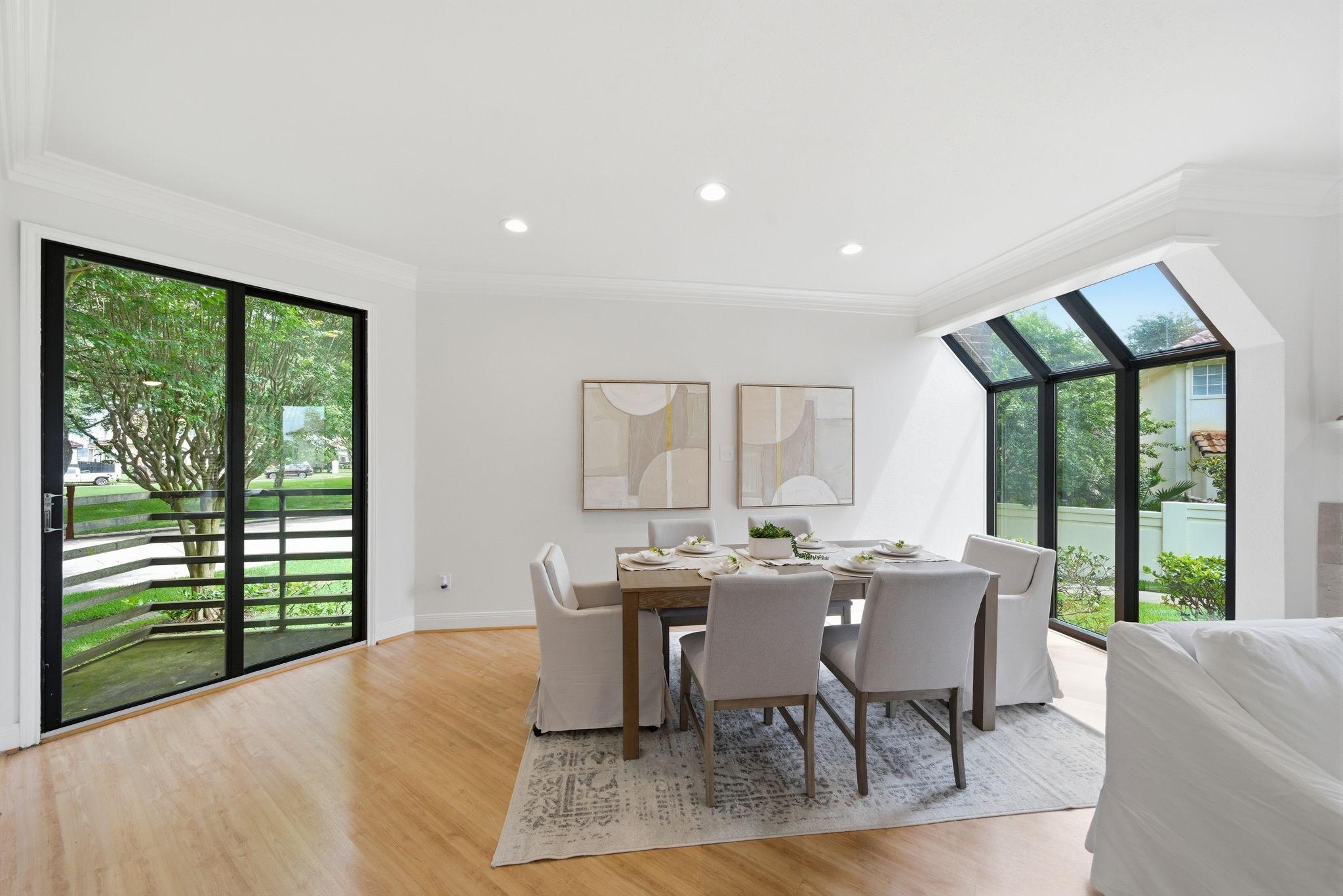 Image 2: DINING ROOM FEATURES WIDE WINDOWS OVERLOOKING BALC