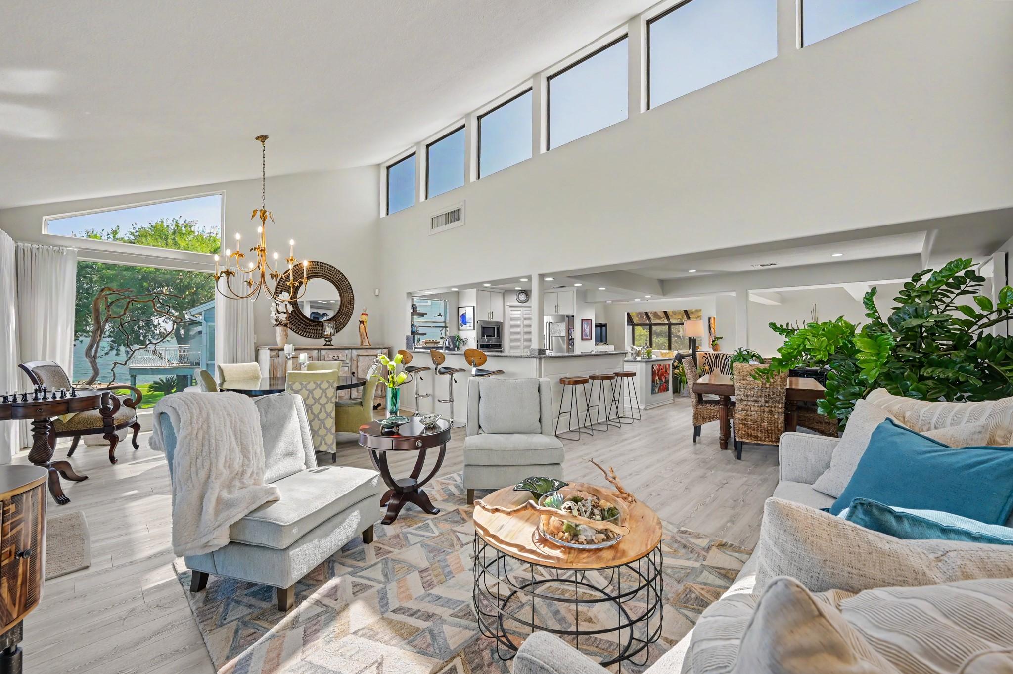 Image 4: The second floor living area is bright with vaulte