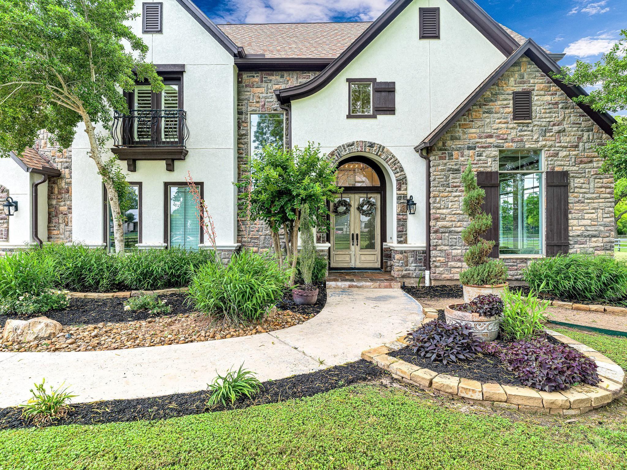 Image 2: Light stucco and richly textured stone!