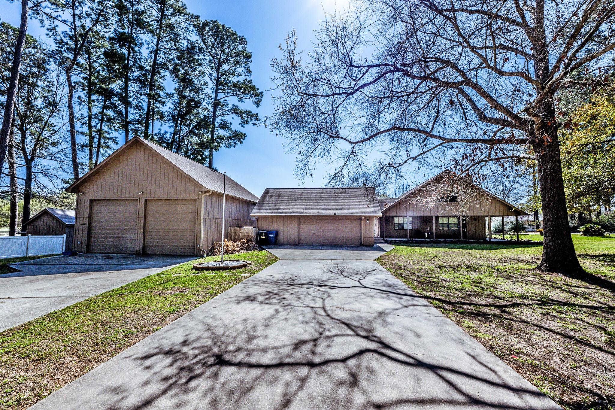 Image 1: Side view of home showing both garages.