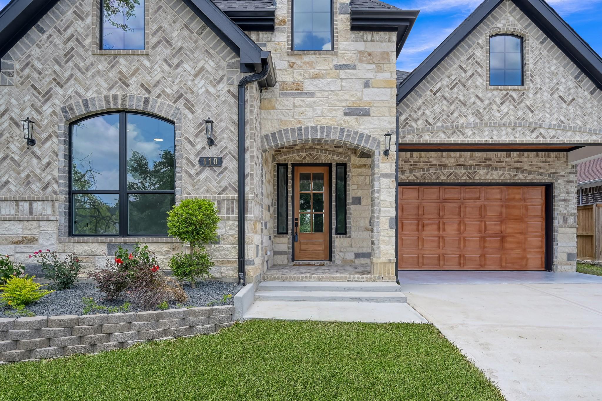 Image 2: Beautiful stone and brick exterior welcomes you ho