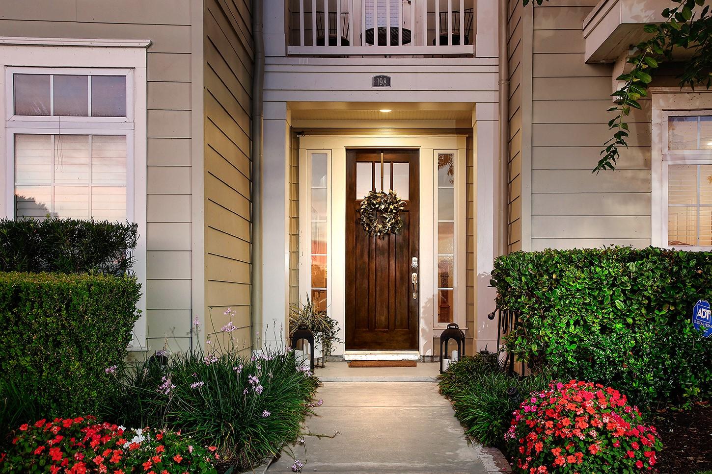 Image 3: Lush landscaping and gorgeous upscale wood stained