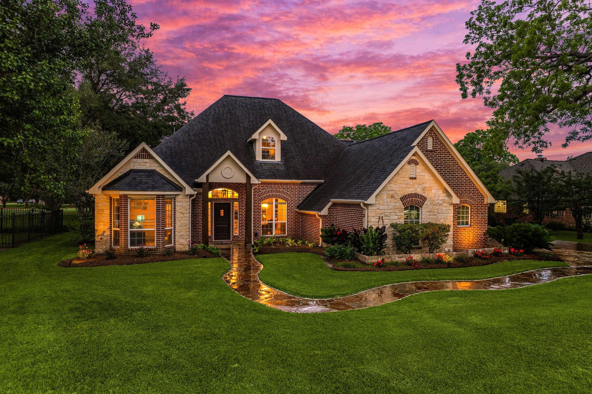 Image 1: Charming brick home with a well-maintained lawn an