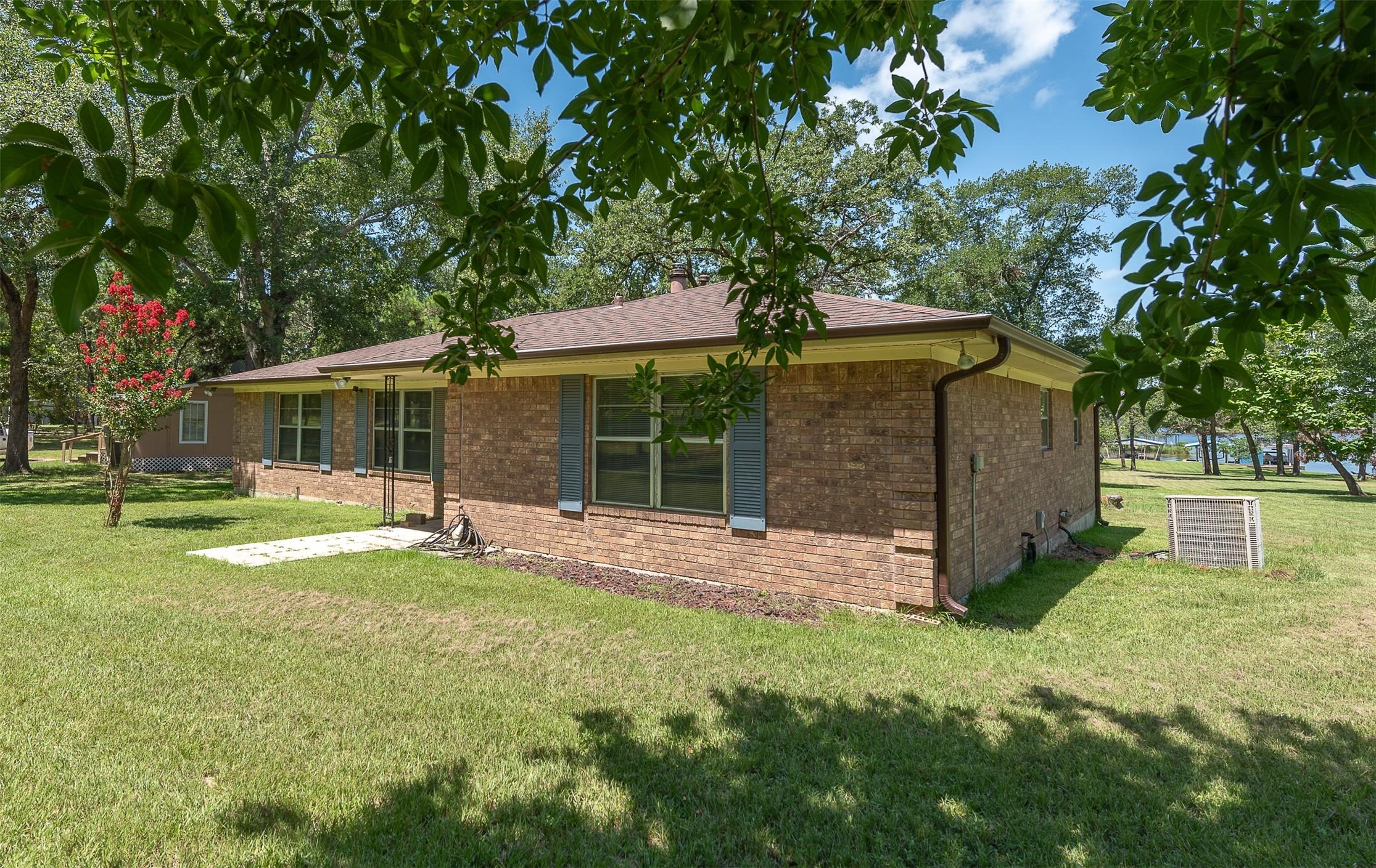 Image 2: Front of the home with a view of the lake to the r