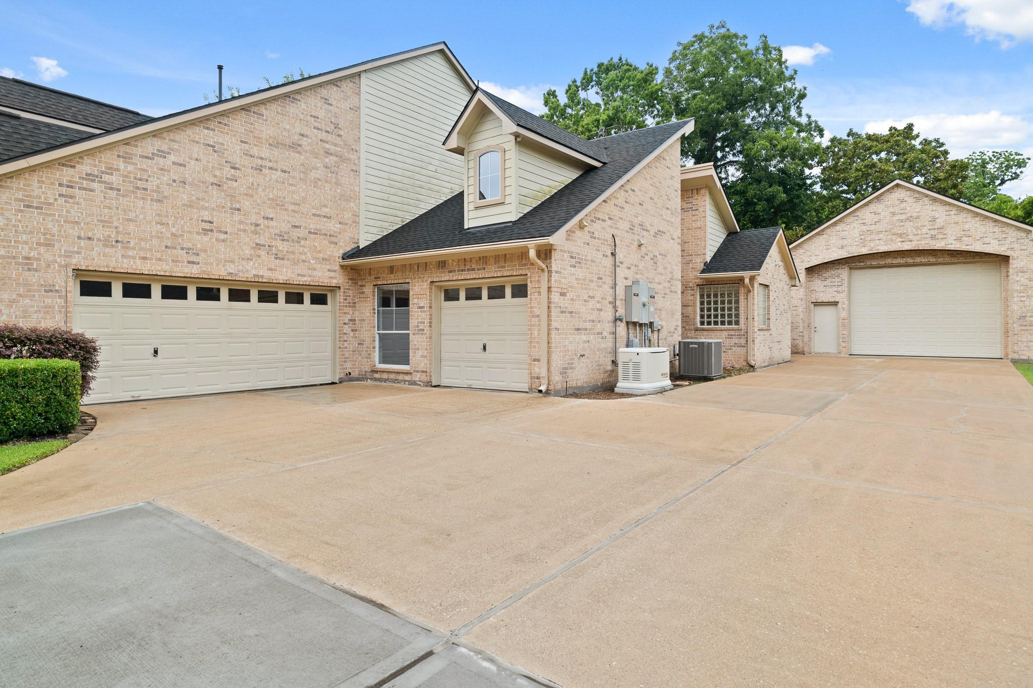 Image 4: The extended driveway leads to the attached 3-car