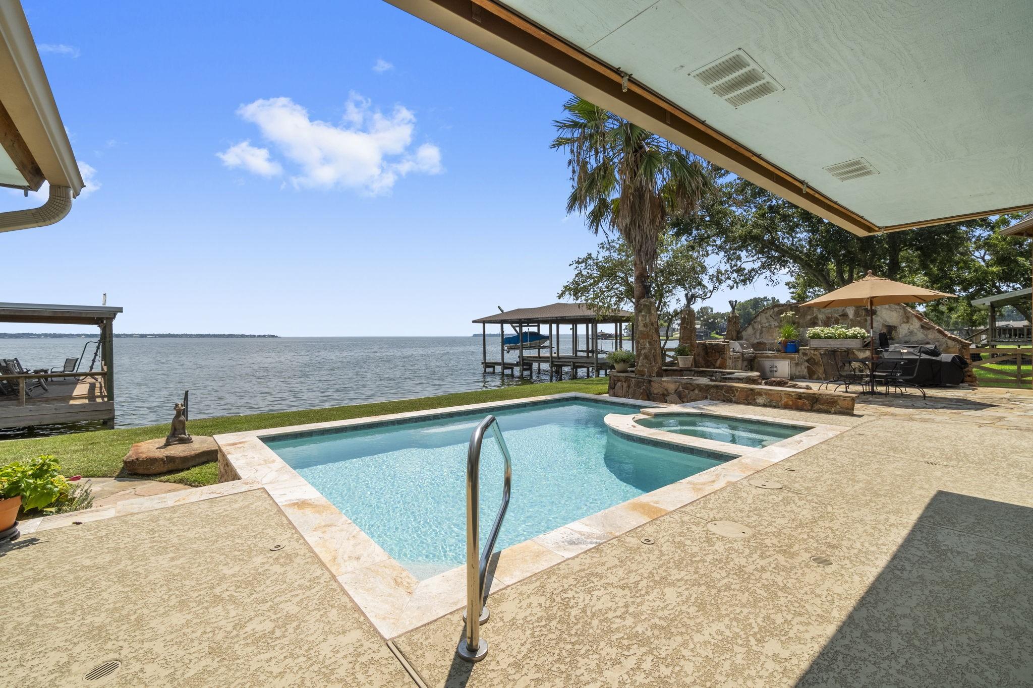 Image 1: This photo showcases a waterfront property with a