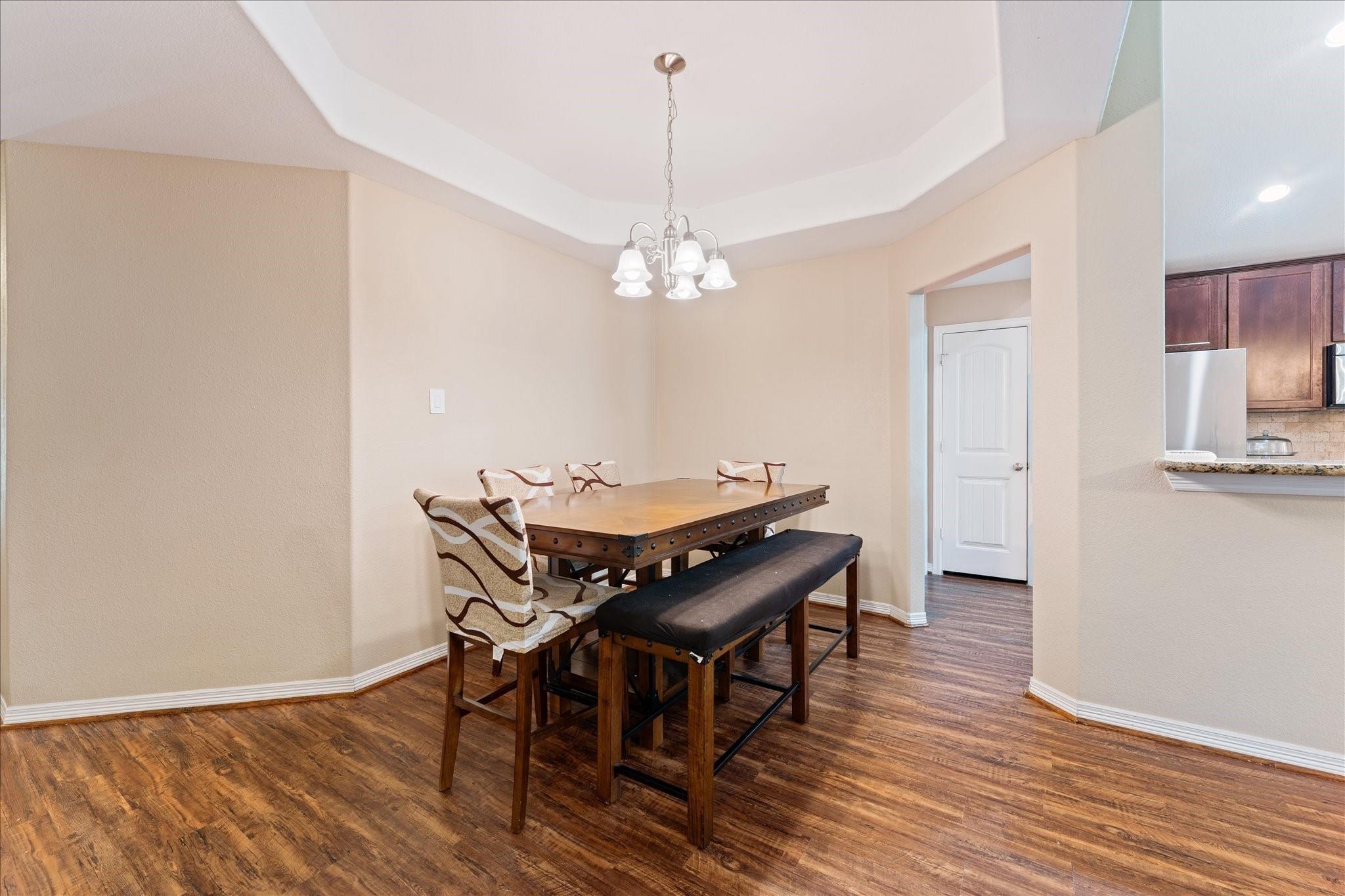 Image 3: Dining room with tray ceiling just off the kitchen