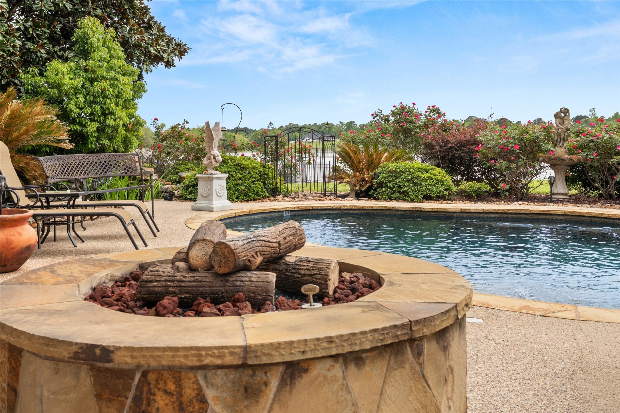 Image 3: Firepit, pool, spa, and lake view. This backyard o