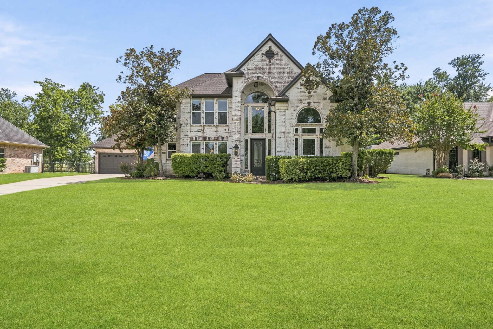 Image 1: Nestled on a quiet street, this striking two-story