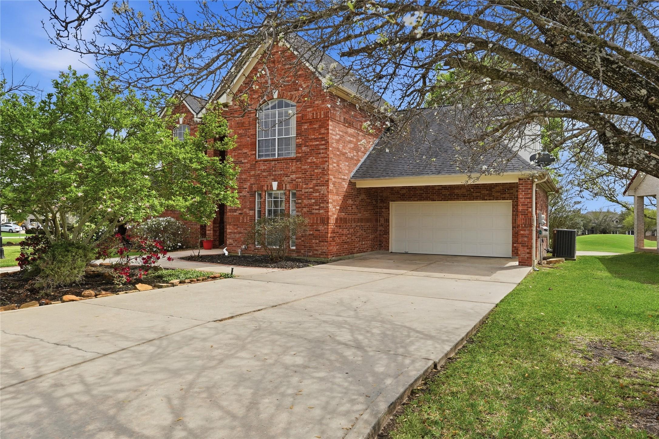 Image 3: This charming brick home features a spacious drive