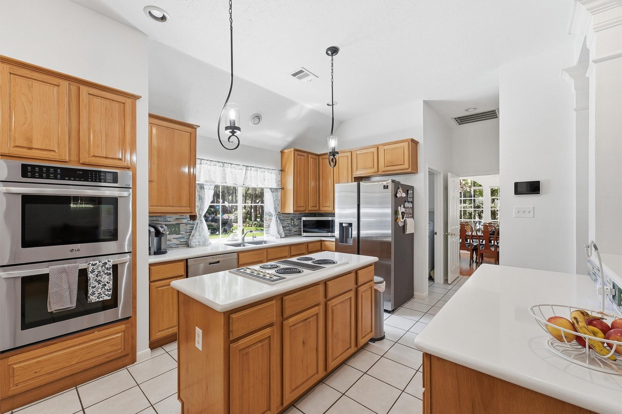 Image 2: Open Kitchen with stainless steel appliances.