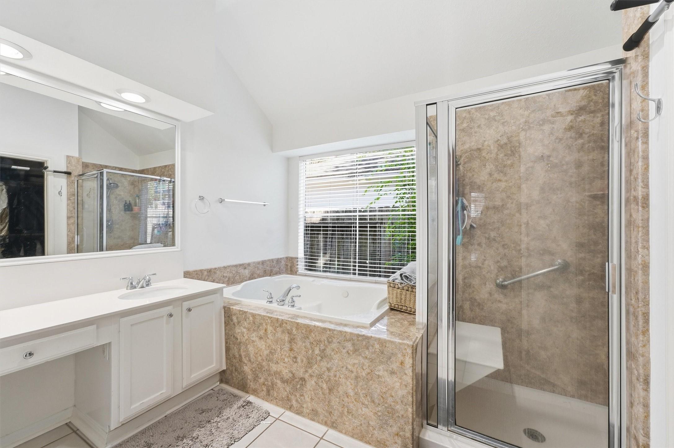 Image 4: Primary Bath with a separate tub and shower.
