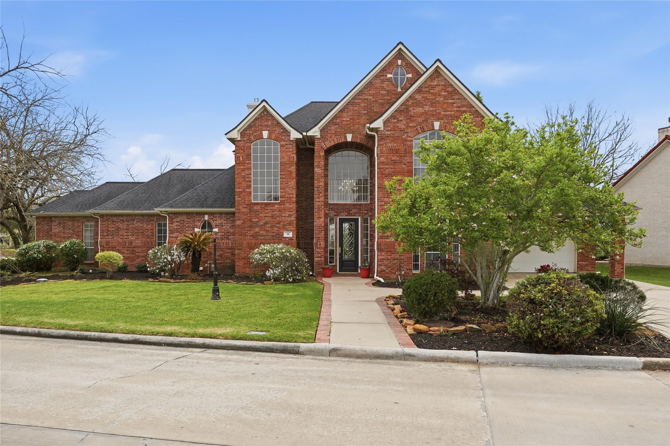 Image 4: This beautiful two-story brick home features a wel