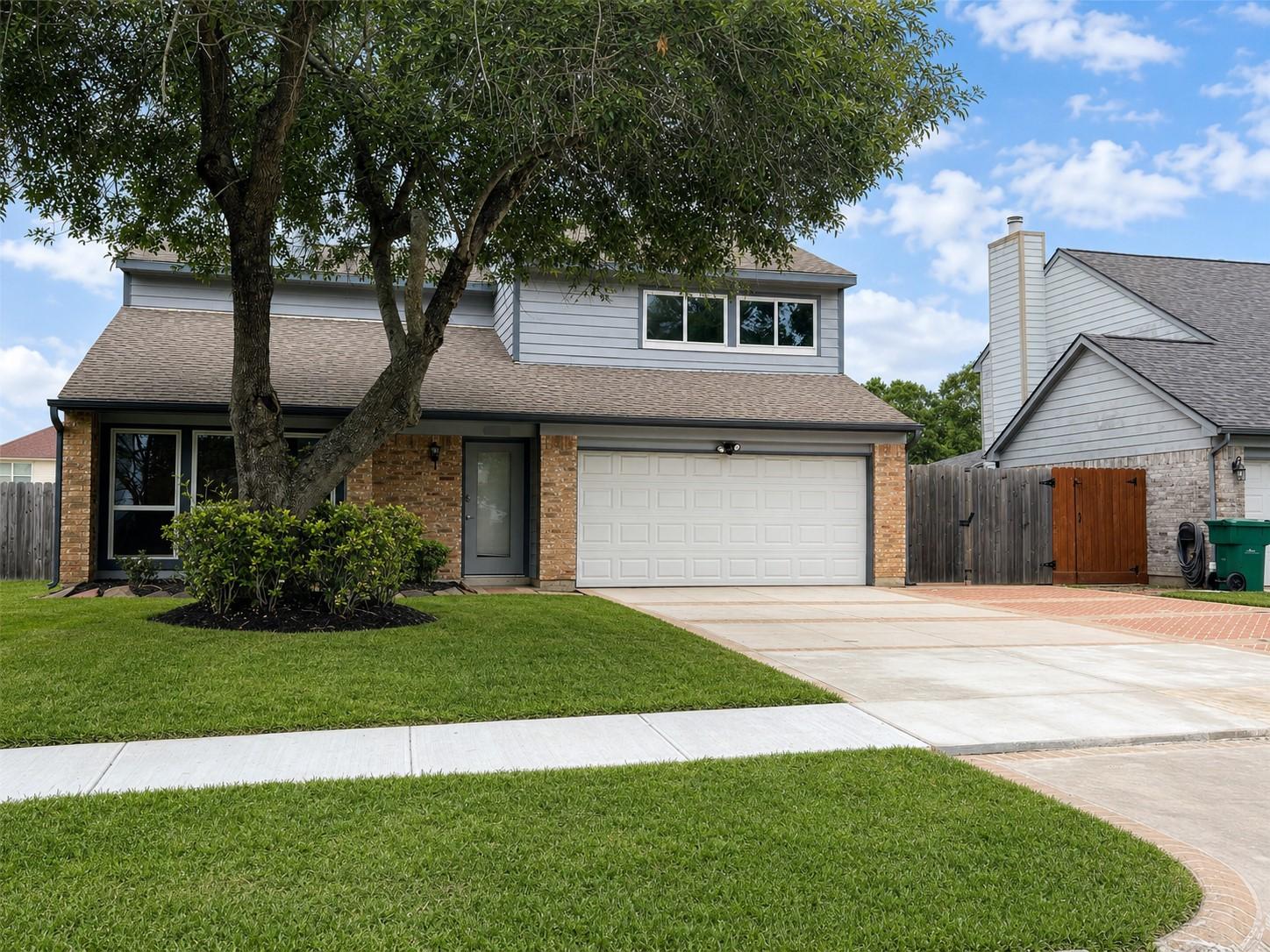 Image 3: Front elevation showing updated siding, brick acce