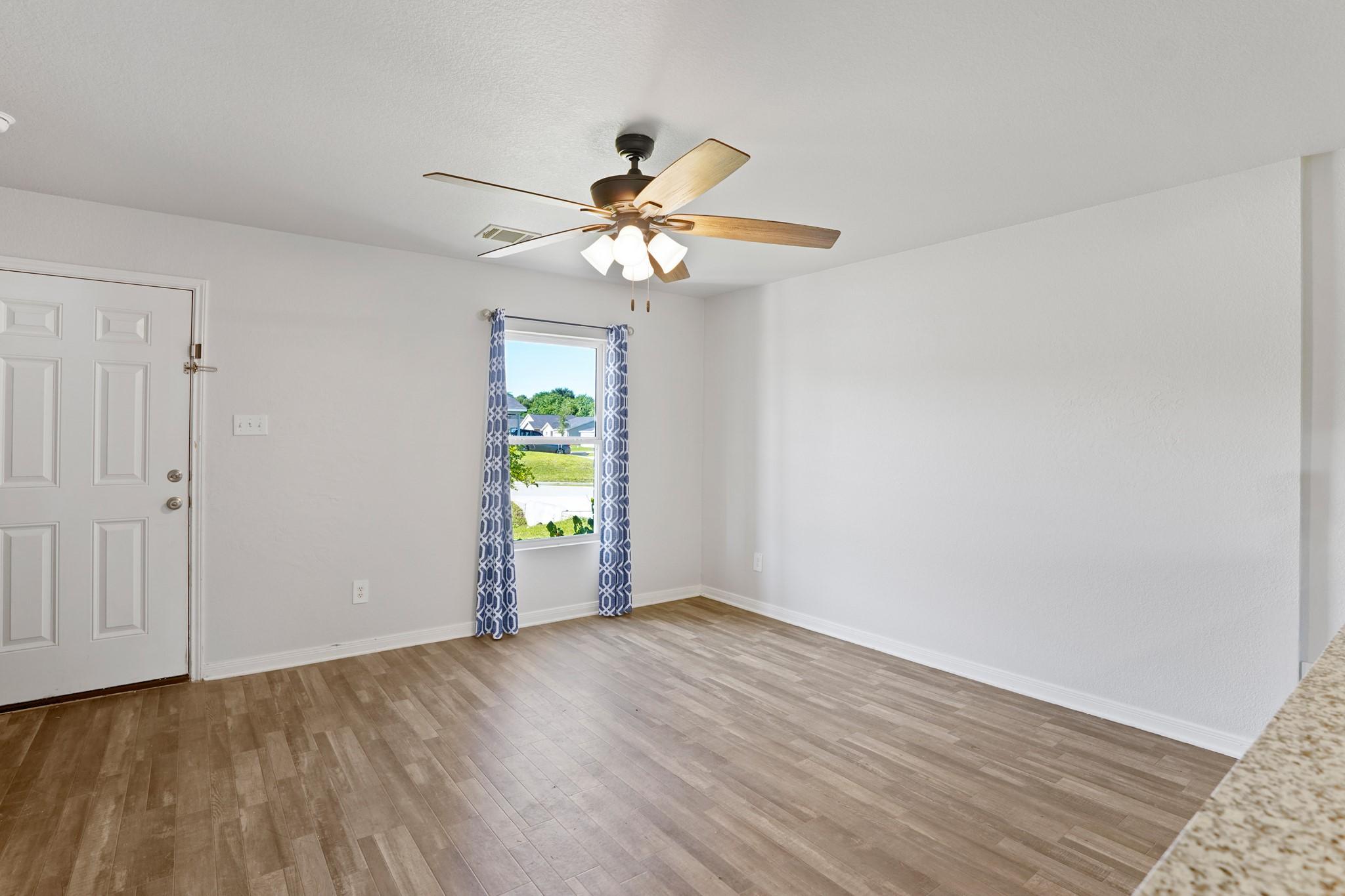 Image 4: Bright and inviting living area featuring wood-sty
