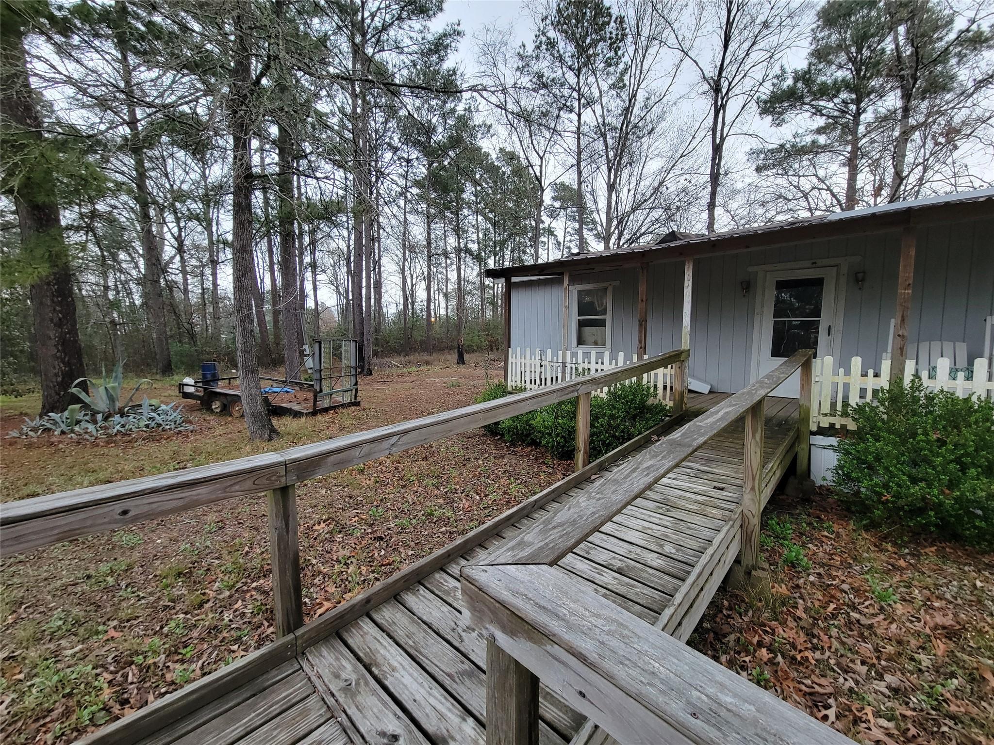 Image 3: Entrance/walkway to the front porch. Property sits