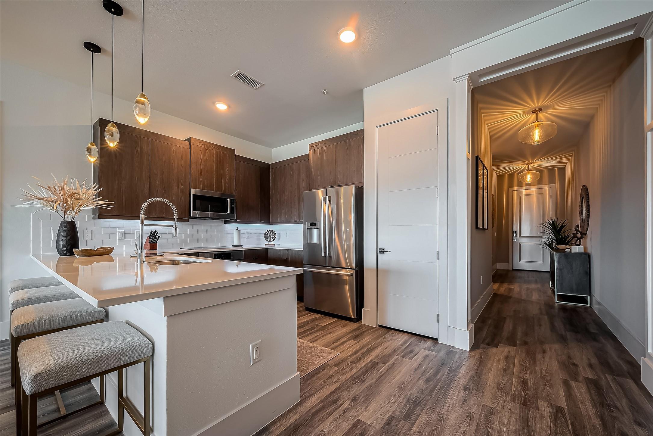 Image 3: High end kitchen with sleek countertops, state of