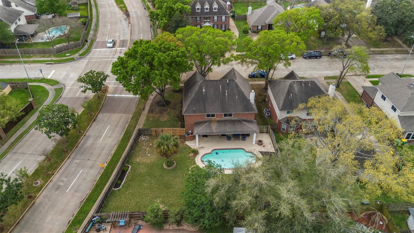 Image 2: Aerial view showcases a suburban home with a spaci