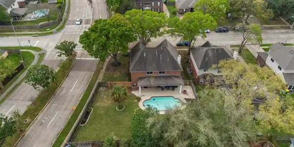 Image 2: Aerial view showcases a suburban home with a spaci