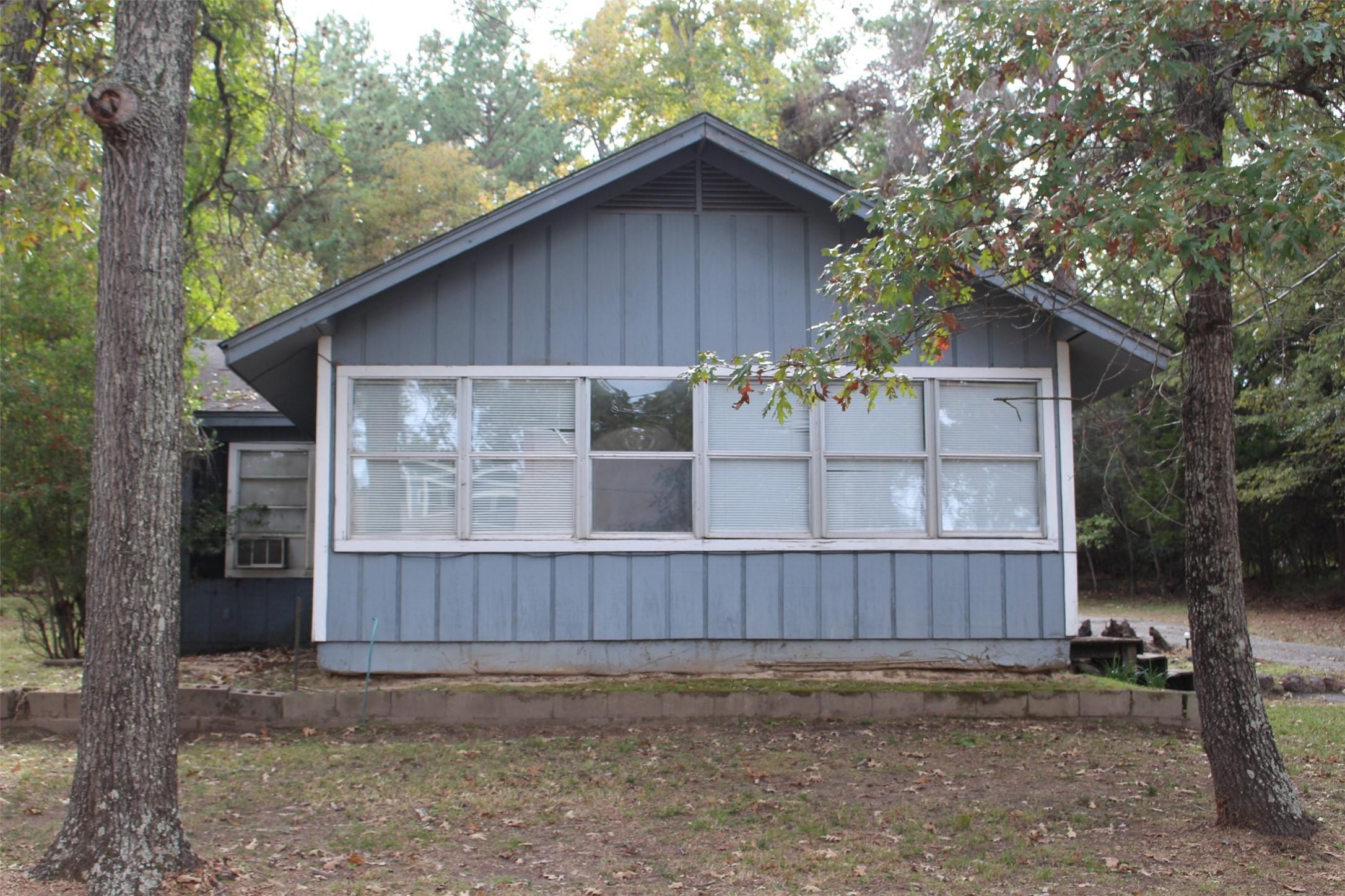 Image 3: Front of the home with all those great windows.
