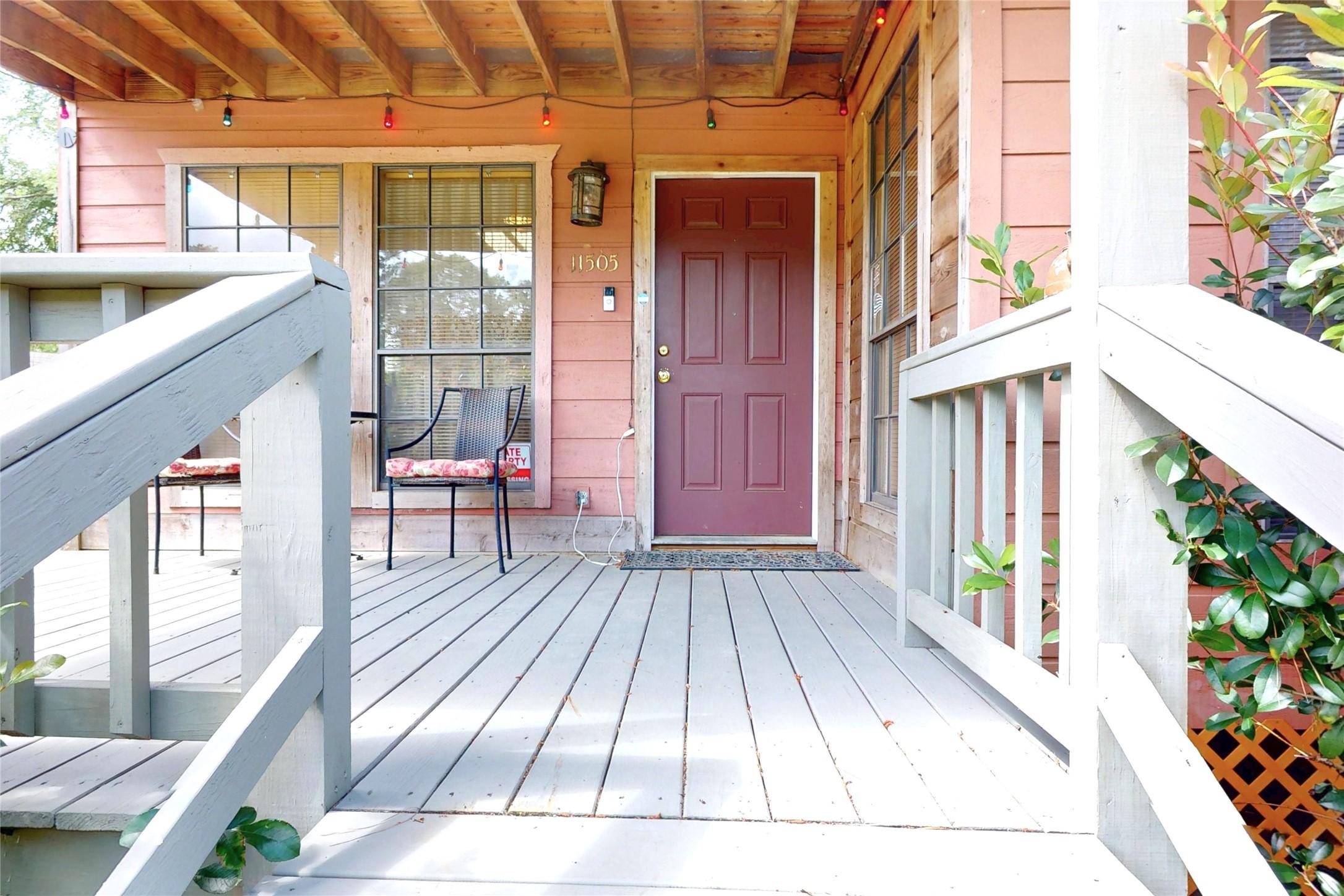 Image 3: Front porch and red door welcomes your guests.