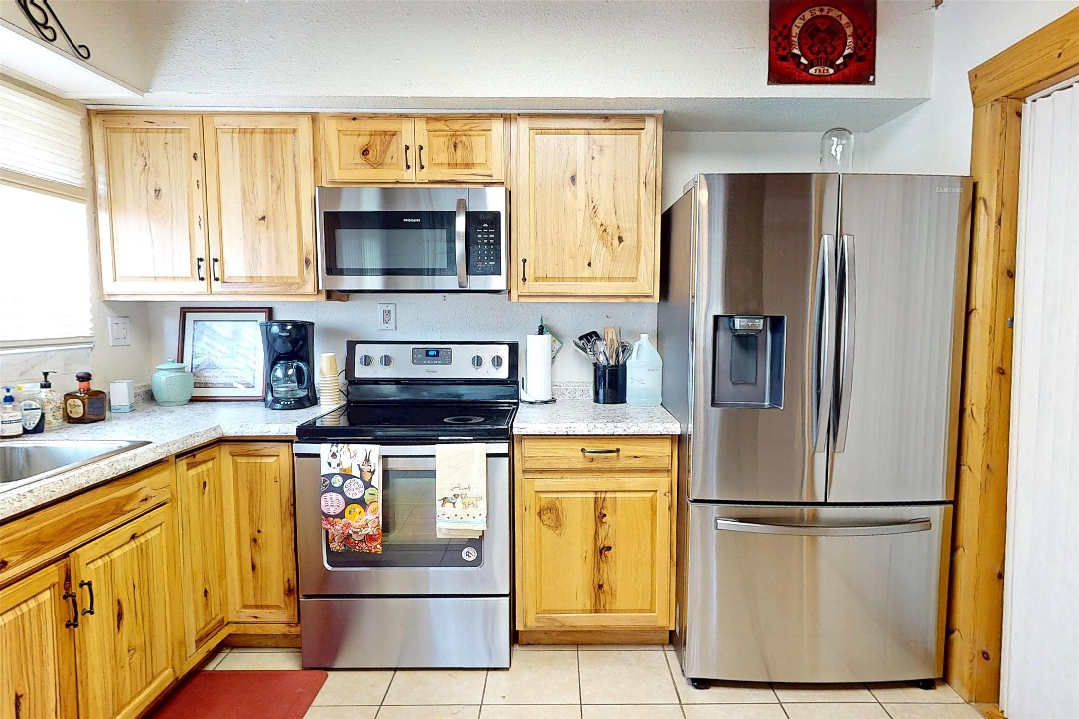 Image 4: This country kitchen features stainless appliances