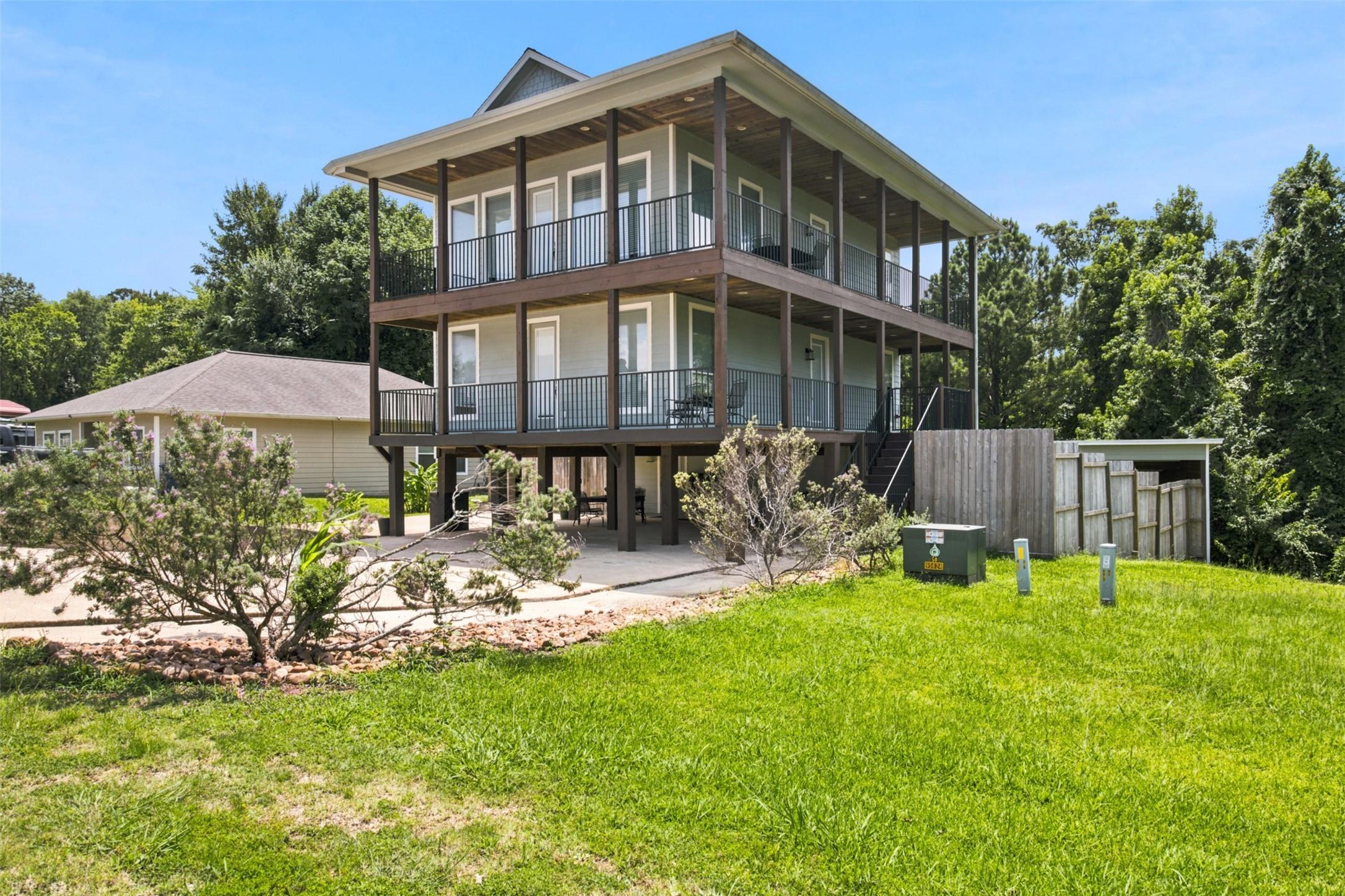 Image 4: Side view of home, fenced back yard