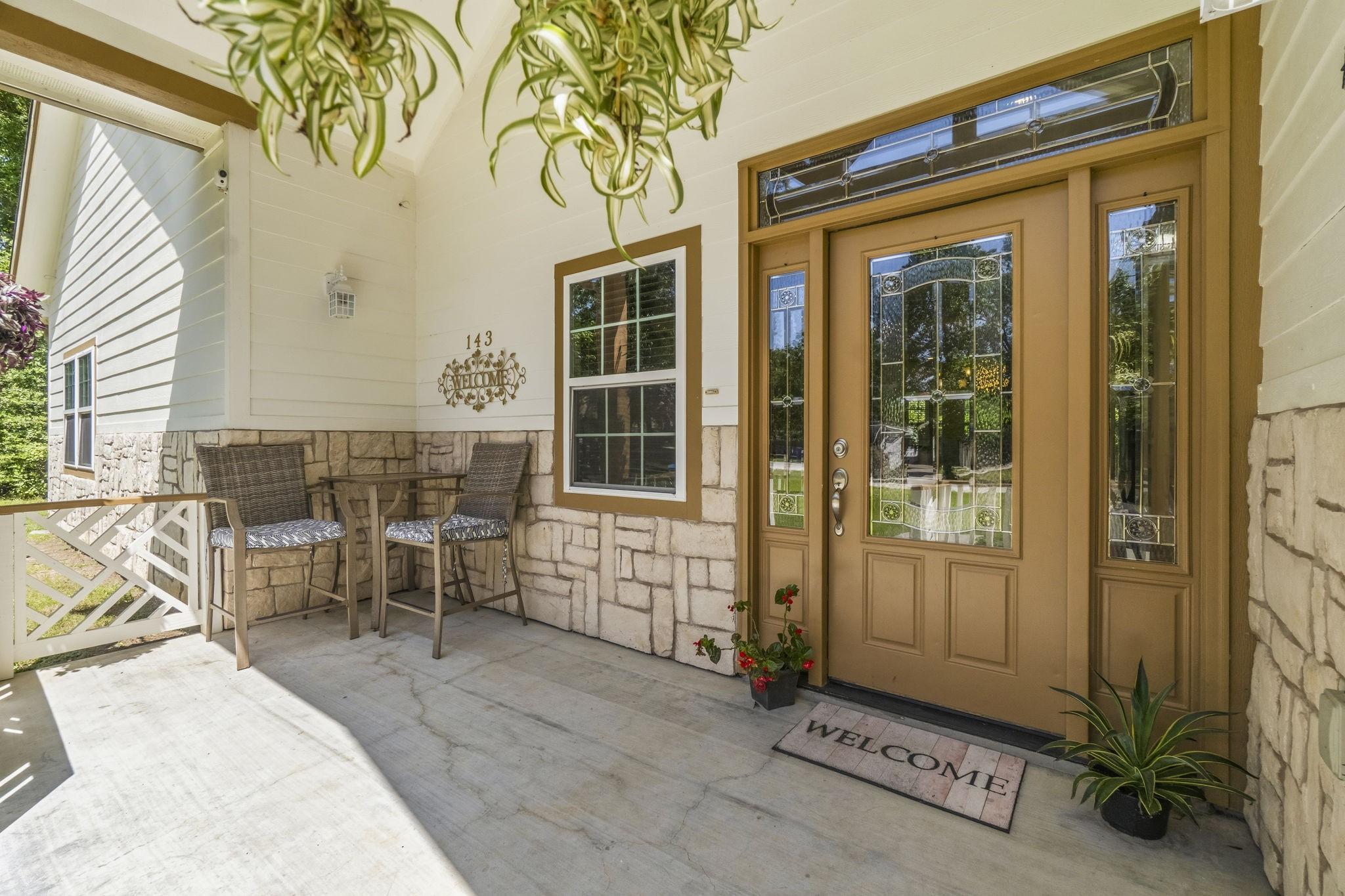 Image 4: Charming front porch with a welcoming glass-panele