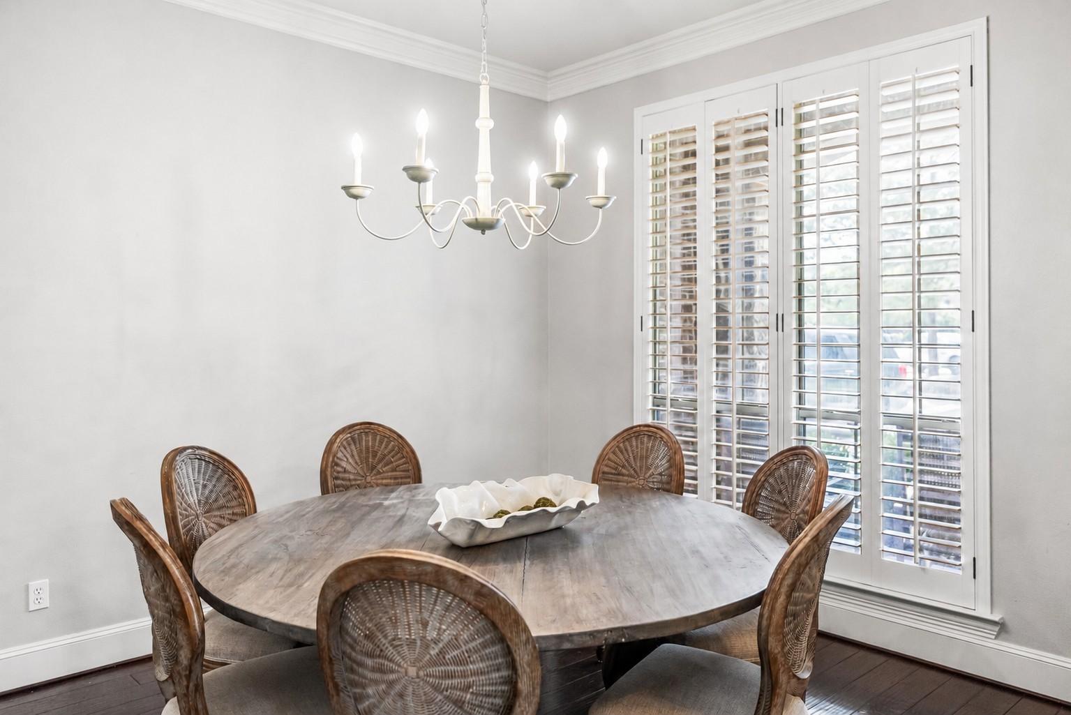Image 4: The spacious dining room features custom lighting,