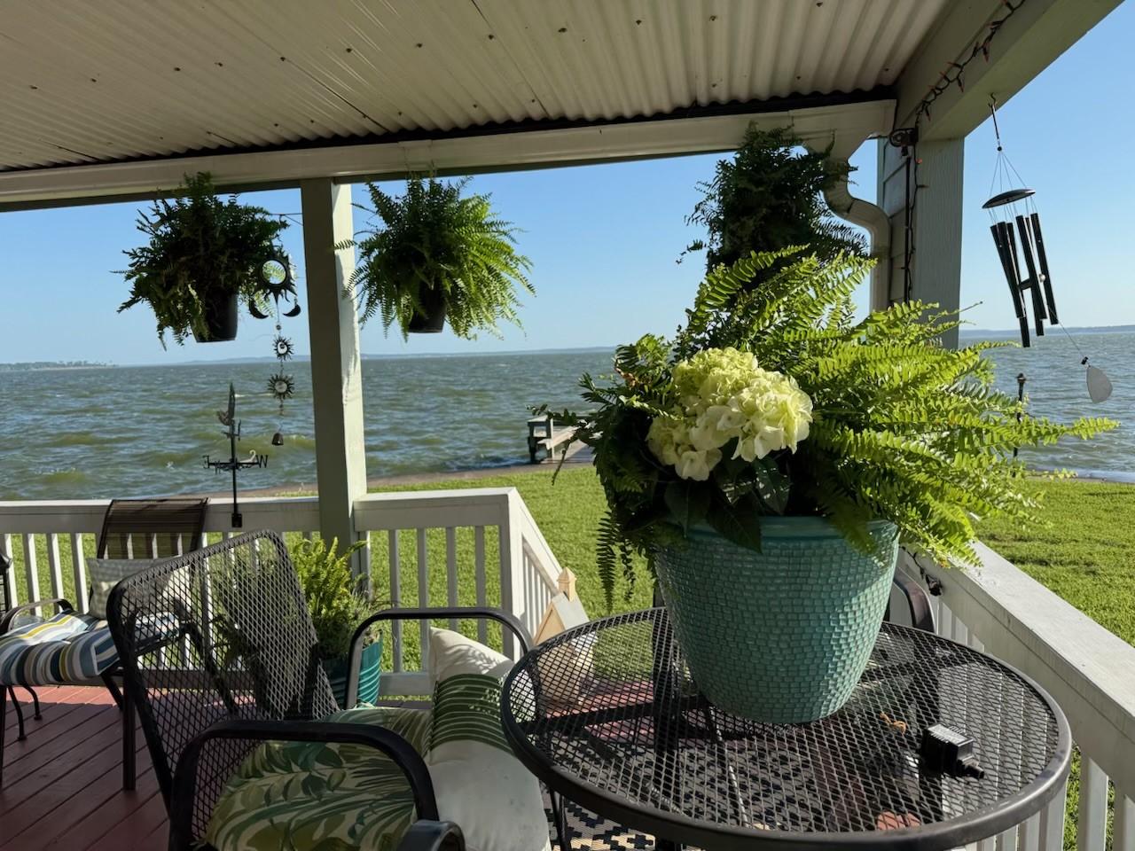 Image 2: Relax and unwind on the covered waterfront porch,