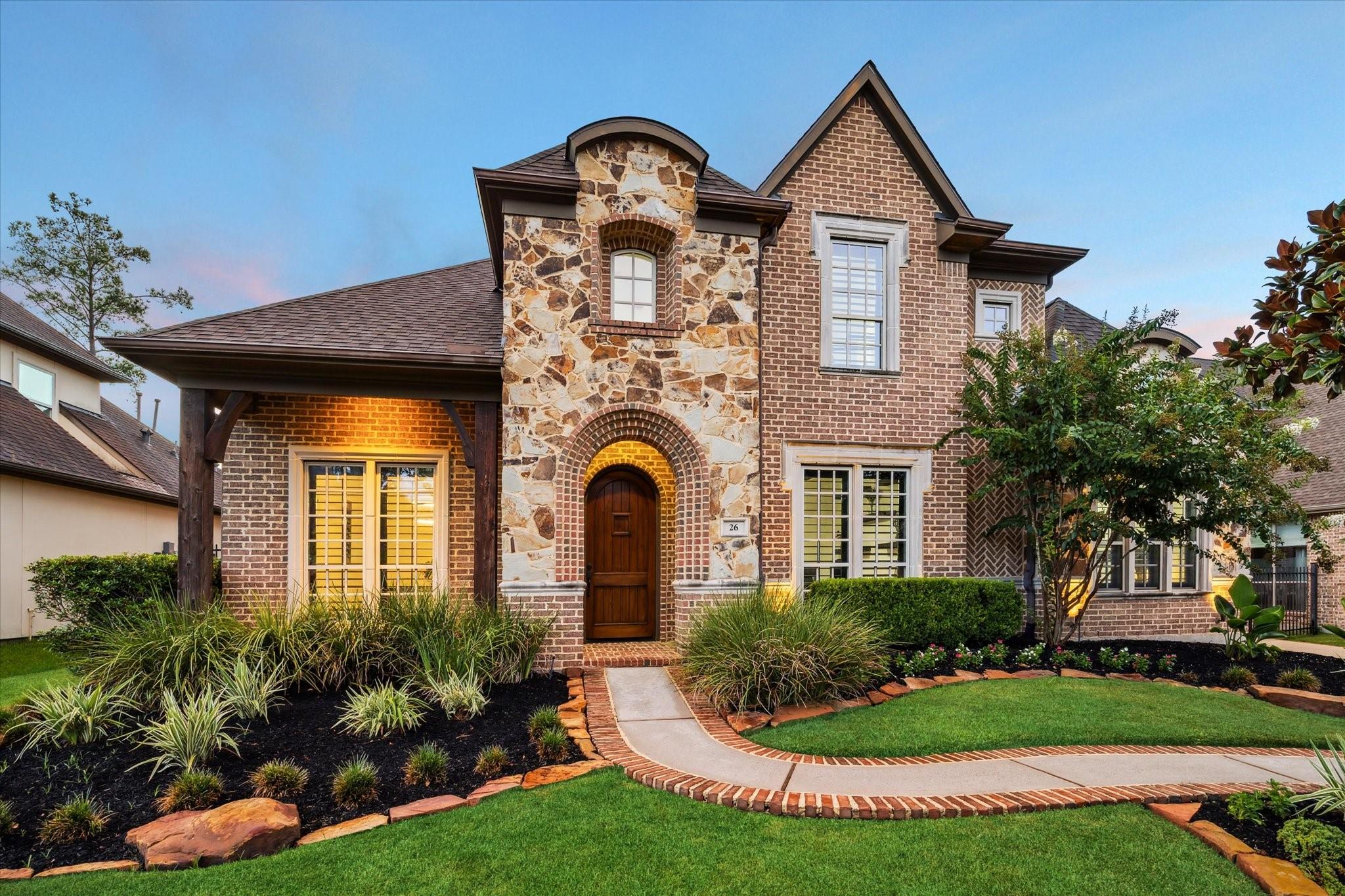 Image 2: The impressive exterior showcases brick and flagst