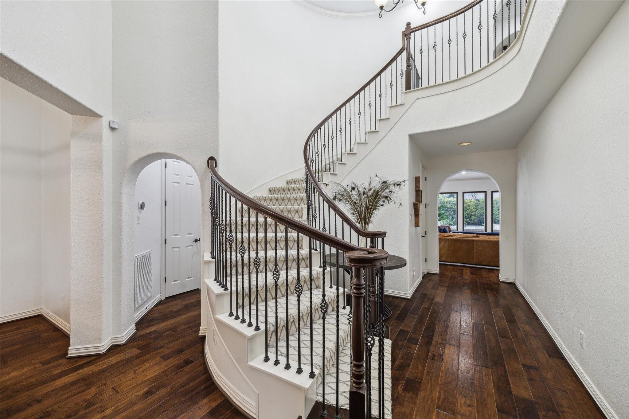 Image 4: Step inside to a dramatic two-story foyer where ri