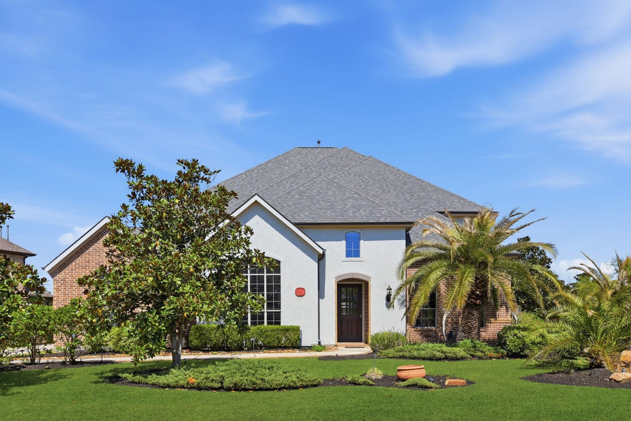Image 1: This photo showcases a modern two-story house with